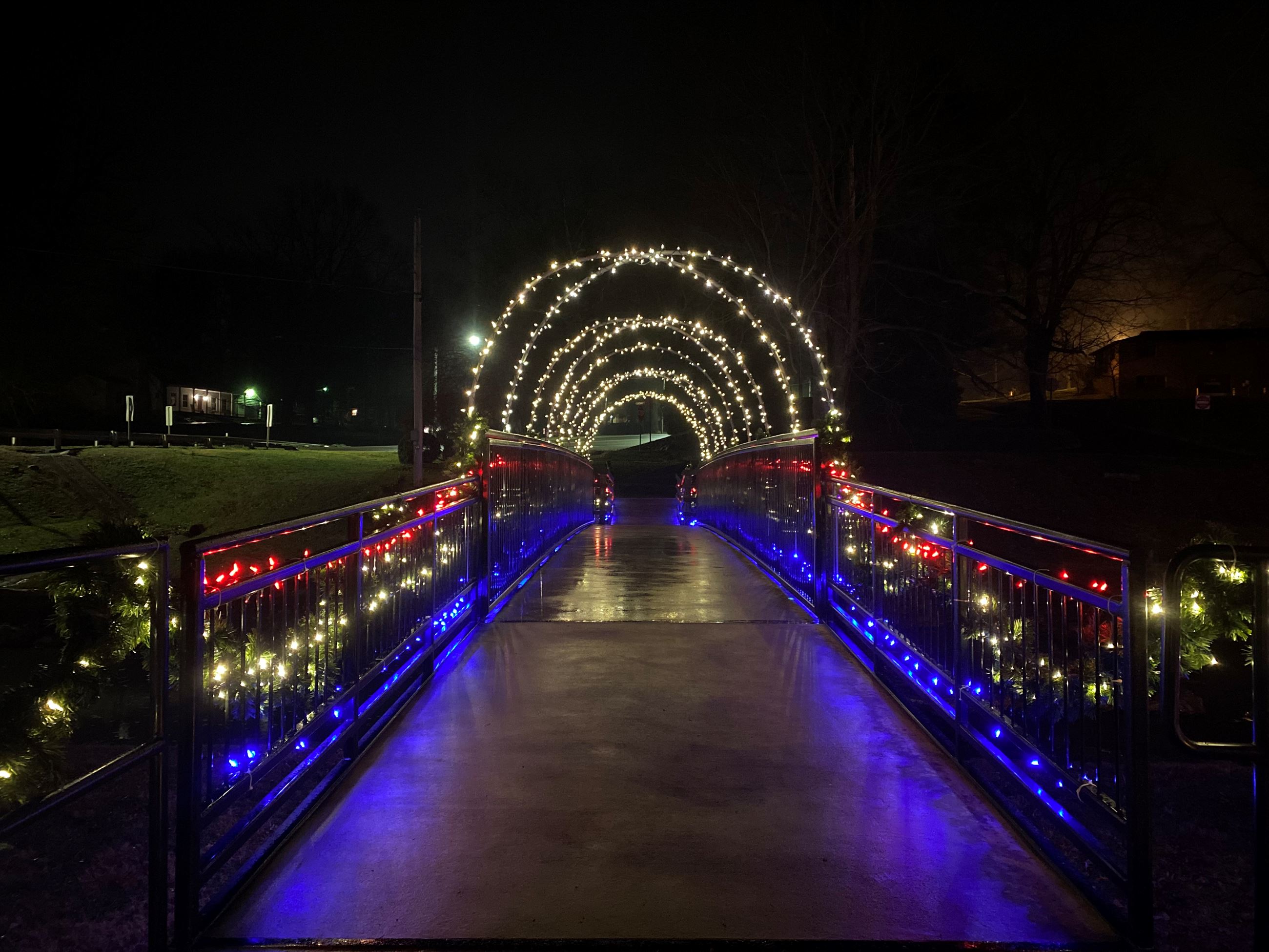 Pedestrian bridge covered in colorful lights